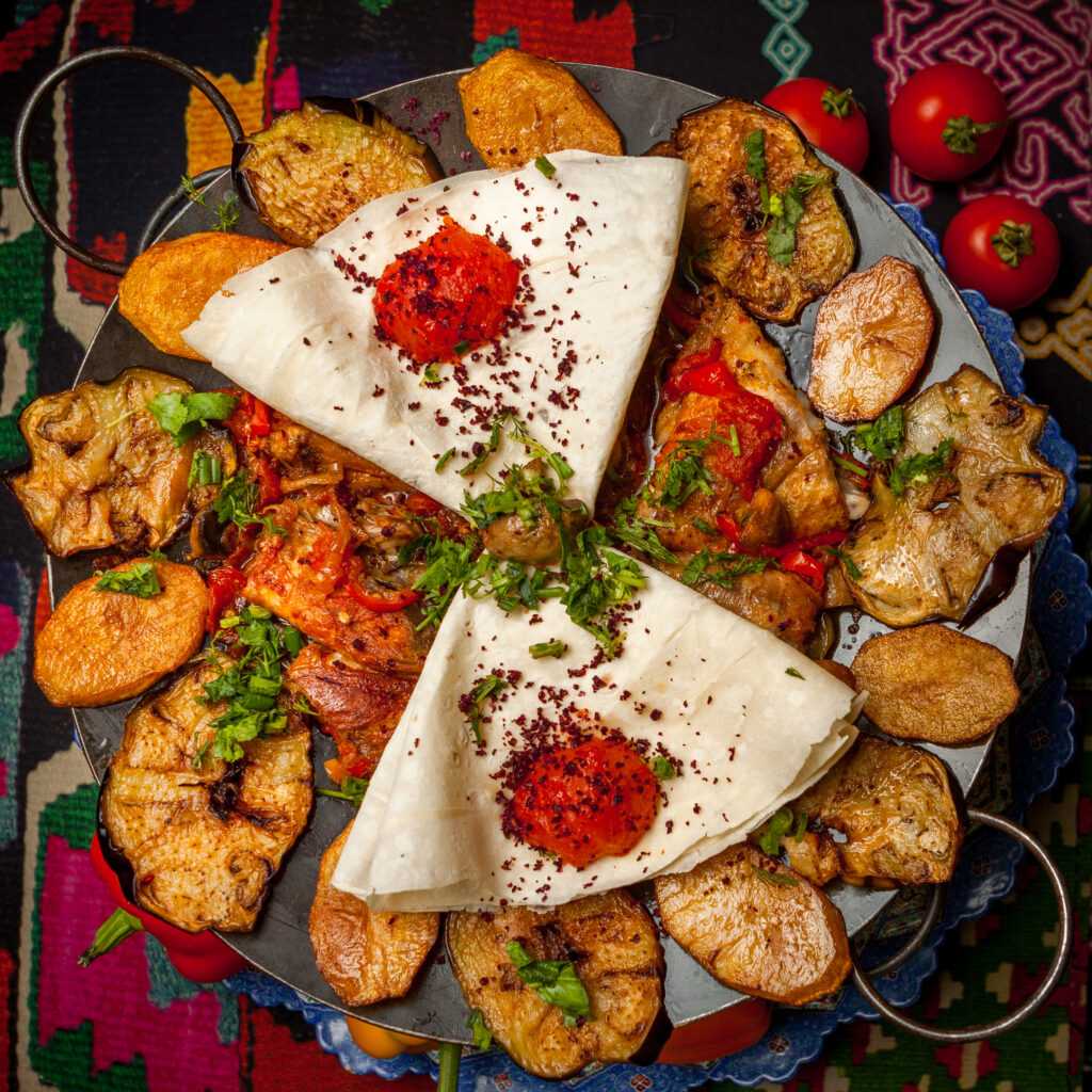 top view chicken sac with lavash and tomato on carpet background